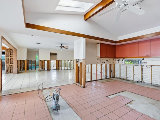 misc room featuring ceiling fan, light tile patterned floors, and lofted ceiling with skylight