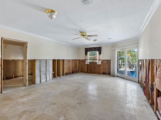 unfurnished room featuring ceiling fan and ornamental molding