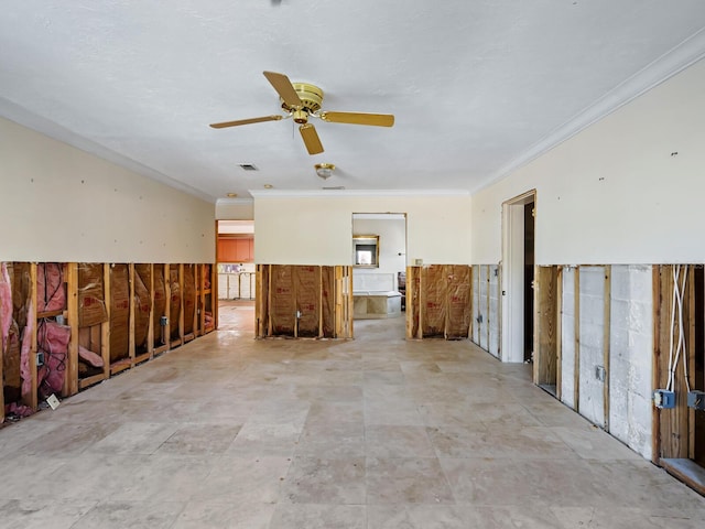 empty room with ceiling fan and crown molding