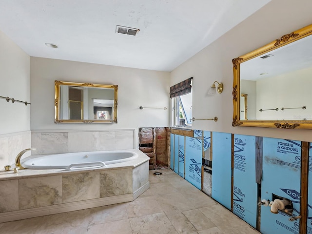 bathroom with a relaxing tiled tub