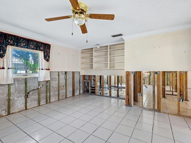 unfurnished room featuring ceiling fan, light tile patterned floors, and crown molding