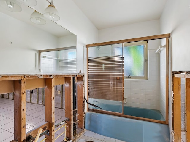 bathroom featuring tile patterned flooring and enclosed tub / shower combo