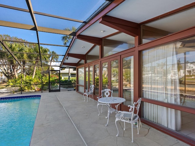 exterior space featuring a patio area and glass enclosure