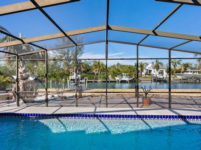 view of pool with a water view, a patio area, and a lanai