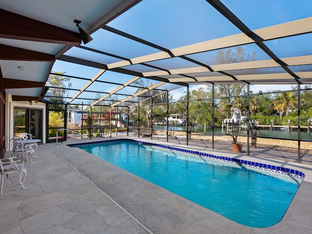 view of pool featuring a lanai, a patio area, and a water view