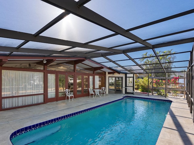 view of swimming pool featuring a lanai and a patio