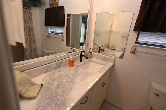 bathroom featuring tile patterned floors, vanity, and toilet