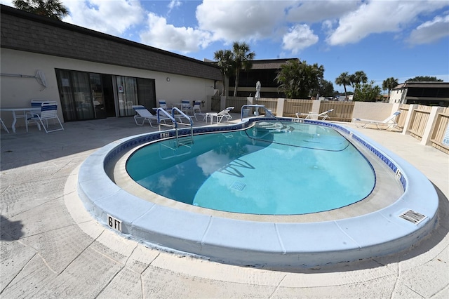 view of swimming pool with a patio area