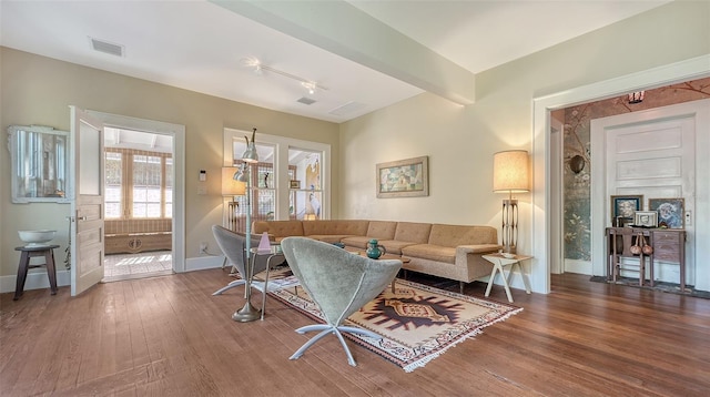 living room featuring beam ceiling and wood-type flooring