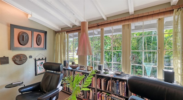 sunroom featuring beam ceiling