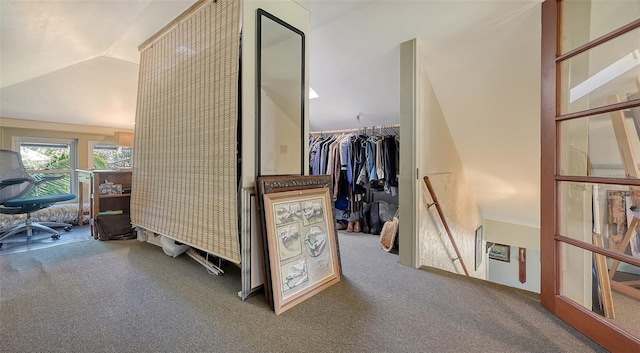 hall featuring carpet and lofted ceiling