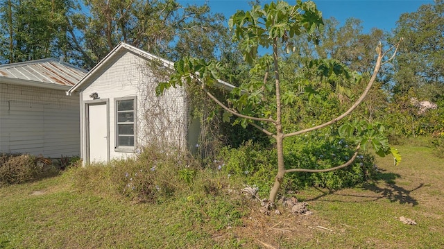 view of side of home featuring a yard