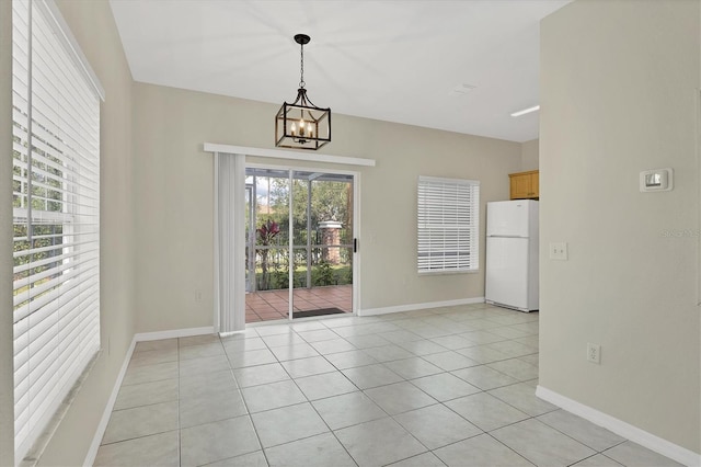 7664 Plantation Cir, Bradenton, FL 34201 - unfurnished dining area featuring an inviting chandelier and light tile patterned flooring