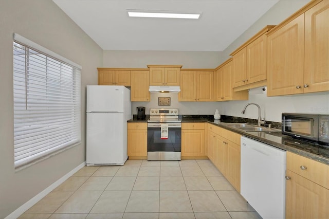 7664 Plantation Cir, Bradenton, FL 34201 - kitchen featuring light brown cabinetry, dark stone counters, white appliances, sink, and light tile patterned floors
