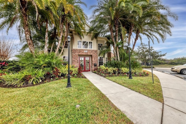 7664 Plantation Cir, Bradenton, FL 34201 - view of front of property with french doors and a front lawn