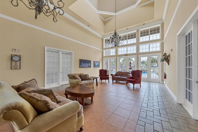 7664 Plantation Cir, Bradenton, FL 34201 - living room featuring a chandelier, french doors, a towering ceiling, and crown molding