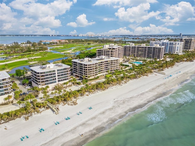 drone / aerial view with a beach view and a water view