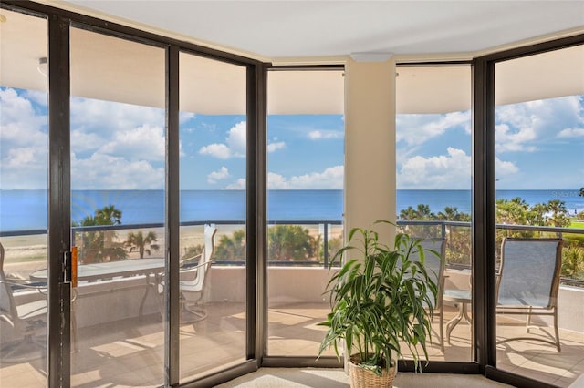 doorway to outside with floor to ceiling windows and a water view