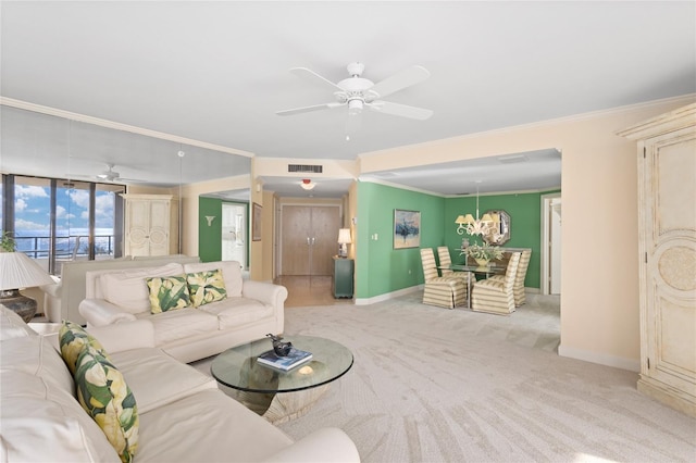 carpeted living room featuring ceiling fan, a wall of windows, and ornamental molding