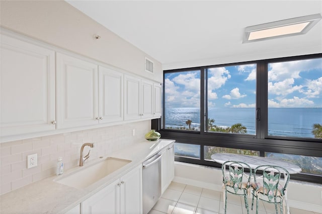 kitchen featuring white cabinets, a water view, stainless steel dishwasher, and sink