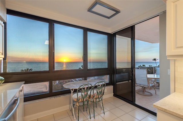 sunroom / solarium with a wealth of natural light and a water view