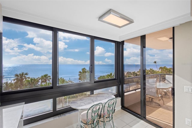 sunroom / solarium with a water view and a wealth of natural light