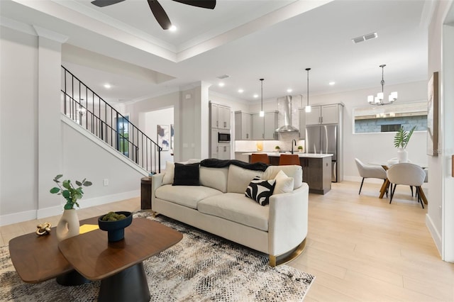 living room with recessed lighting, visible vents, ornamental molding, stairway, and light wood finished floors