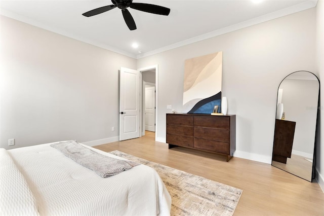 bedroom with crown molding, ceiling fan, baseboards, and light wood-style floors