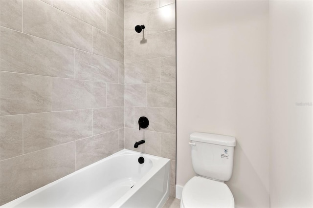 bathroom with washtub / shower combination and toilet