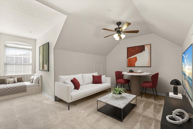 living room featuring ceiling fan, carpet, and vaulted ceiling