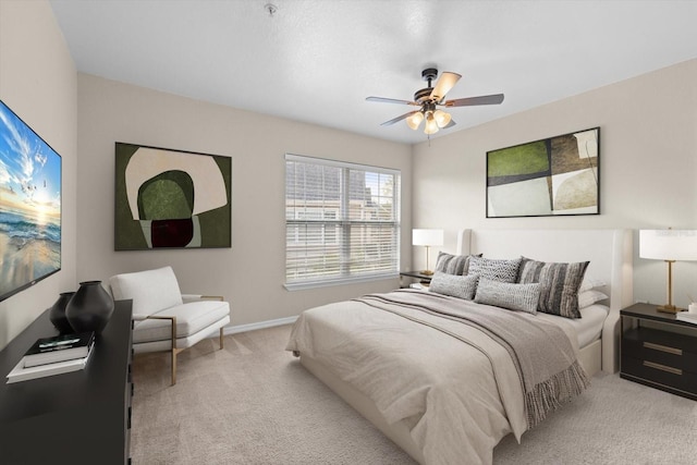 bedroom featuring light colored carpet and ceiling fan