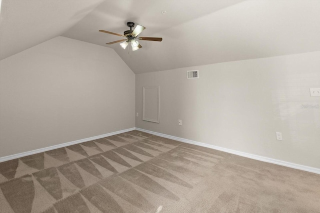 additional living space with ceiling fan, carpet, and vaulted ceiling