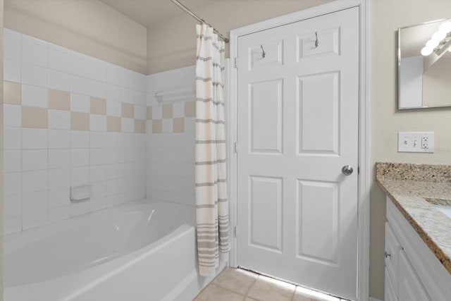 bathroom with tile patterned floors, shower / bath combo with shower curtain, and vanity