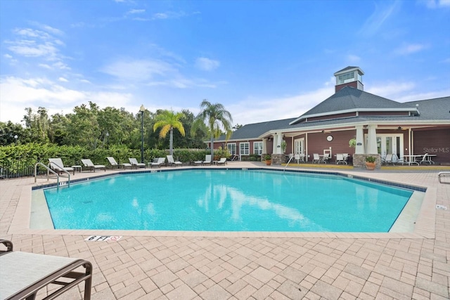 view of swimming pool featuring french doors and a patio