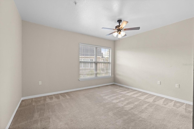 carpeted spare room with ceiling fan