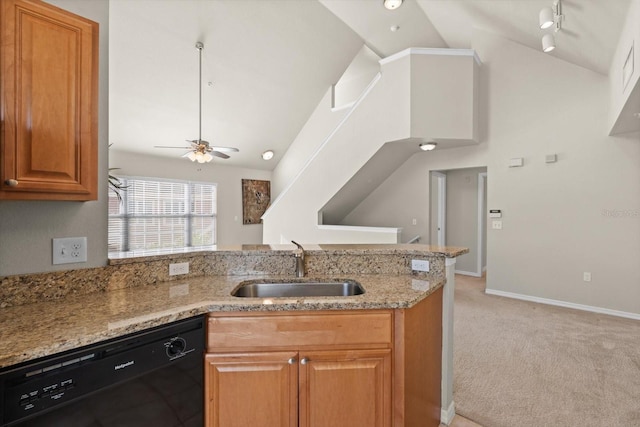 kitchen featuring light stone counters, light colored carpet, ceiling fan, sink, and dishwasher