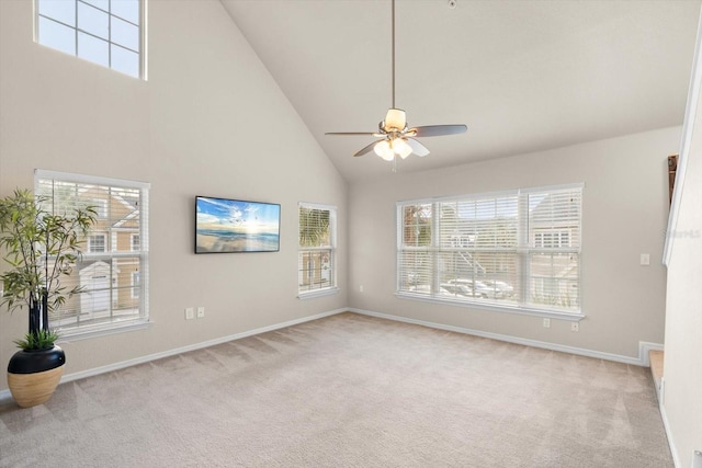 interior space featuring ceiling fan, light carpet, and high vaulted ceiling