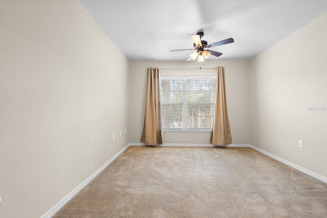 empty room featuring ceiling fan and light colored carpet