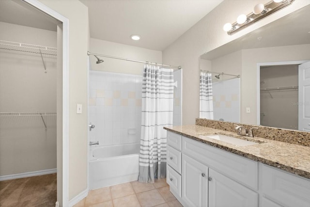 bathroom with tile patterned floors, shower / bath combo with shower curtain, and vanity