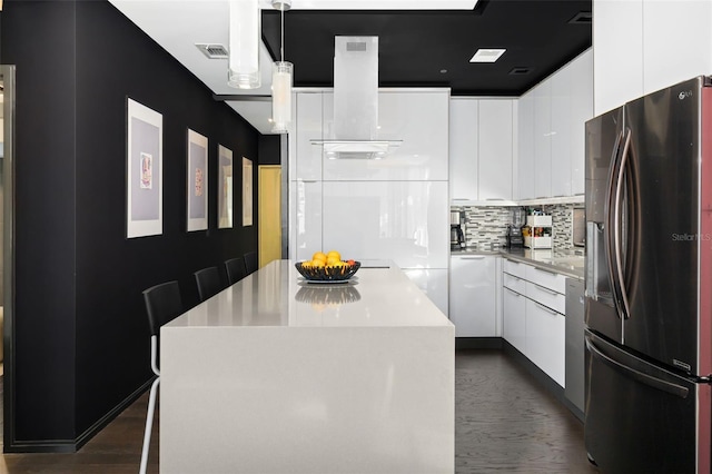 kitchen featuring white cabinets, hanging light fixtures, stainless steel refrigerator with ice dispenser, and a kitchen island