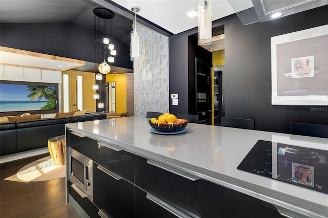 kitchen featuring hanging light fixtures and vaulted ceiling