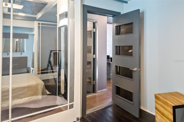 bathroom with hardwood / wood-style floors