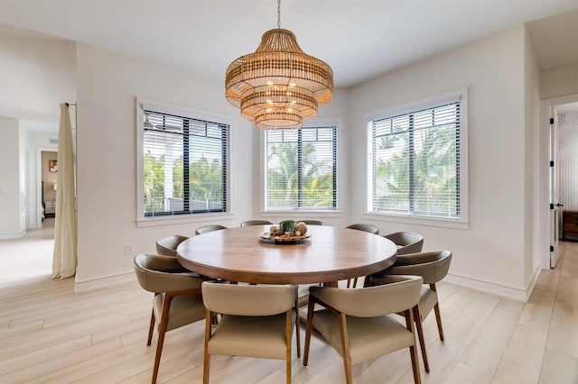 dining room with an inviting chandelier and light wood-type flooring