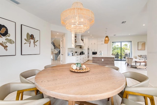 dining space with an inviting chandelier and sink