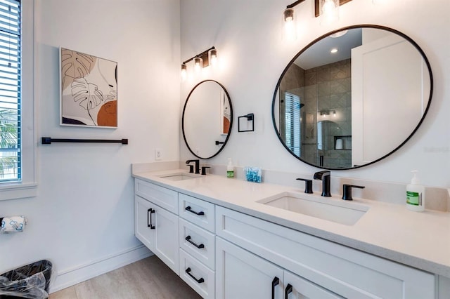 bathroom featuring an enclosed shower, vanity, and wood-type flooring