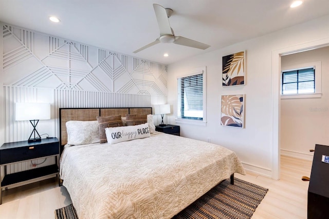 bedroom with ceiling fan and light wood-type flooring