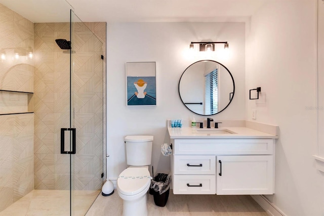 bathroom with vanity, an enclosed shower, and toilet