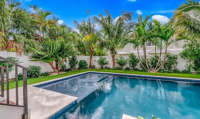 view of pool featuring a lawn