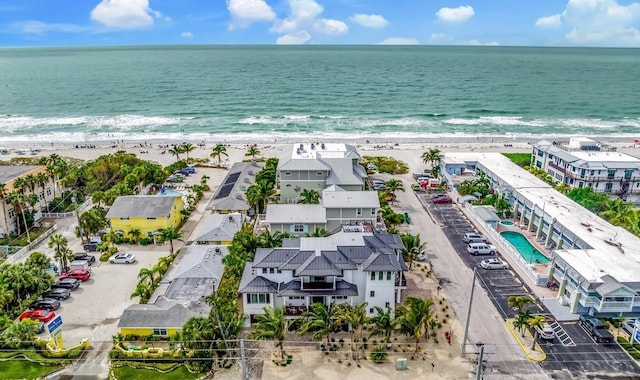 drone / aerial view featuring a water view and a beach view