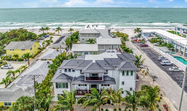 birds eye view of property with a view of the beach and a water view